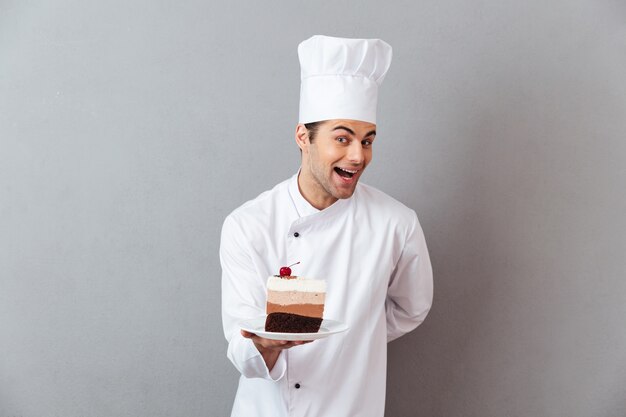 Retrato de um chef masculino animado sorridente, vestido de uniforme