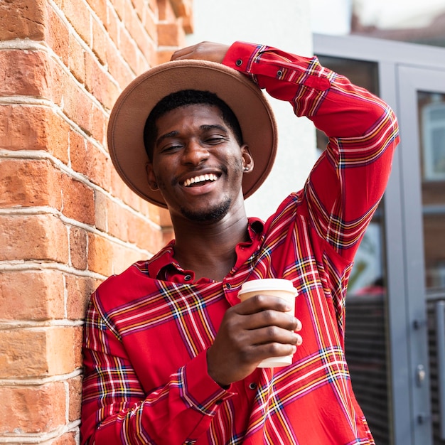 Retrato de um homem feliz segurando o chapéu