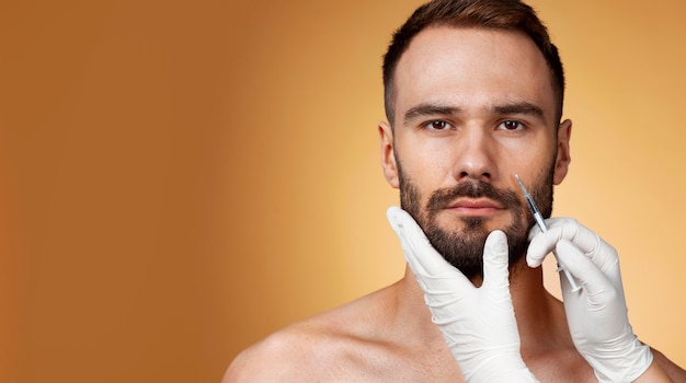 Retrato de um homem recebendo aprimoramentos e ajustes através da ajuda de procedimentos cosméticos.