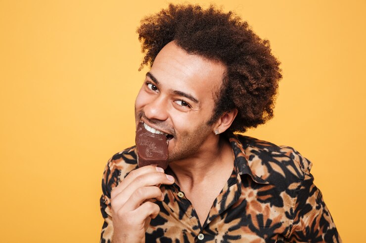 Foto grátis retrato de um jovem africano feliz comendo sorvete
