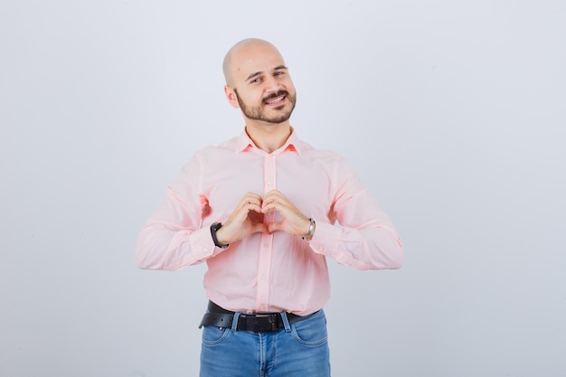 Retrato de um jovem confiante mostrando um gesto de coração