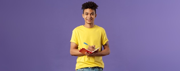 Foto grátis retrato de um jovem estudante hispânico estudando cursos on-line escrevendo palestras pessoais