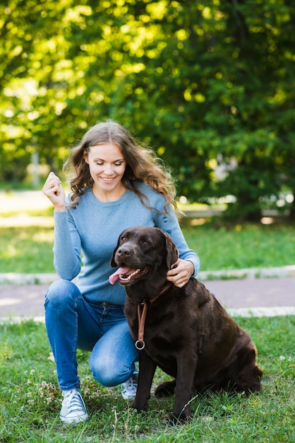 Retrato, de, um, sorrindo, mulher jovem, e, dela, cão, em, jardim