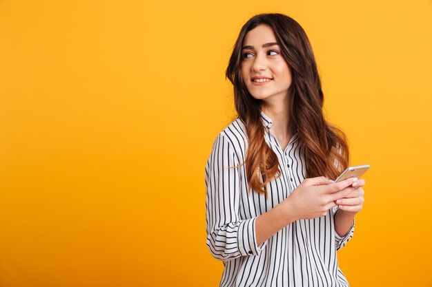 Retrato de uma jovem garota segurando o telefone móvel