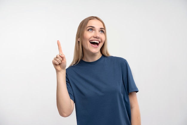 Retrato de uma jovem sorrindo e apontando