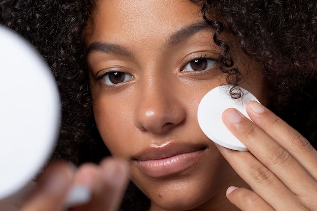 Foto grátis retrato de uma linda mulher negra fazendo sua rotina de cuidados com a pele