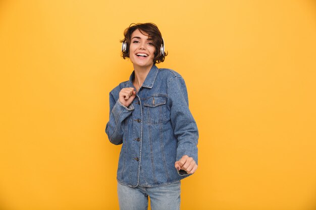 Retrato de uma mulher feliz e positiva, vestida de jaqueta jeans