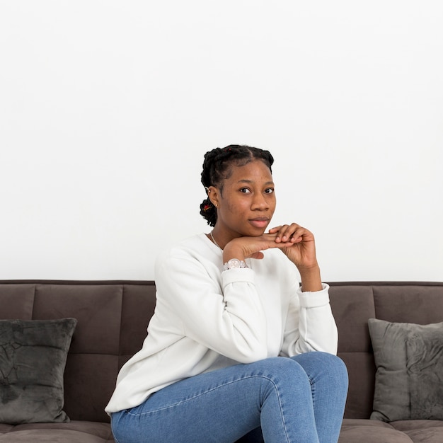 Foto grátis retrato jovem mulher sentada no sofá