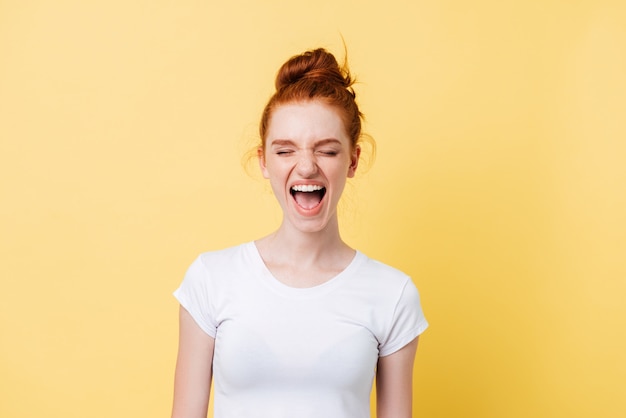 Foto grátis rindo mulher ruiva de camiseta com os olhos fechados