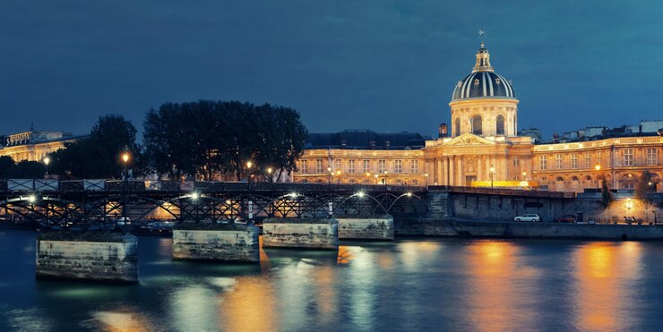 Foto grátis rio sena com panorama pont des arts e institut de france à noite em paris, frança.
