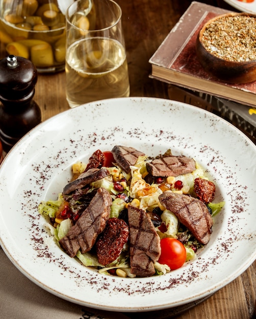 Salada de carne grelhada com alface, tomate cereja e passas