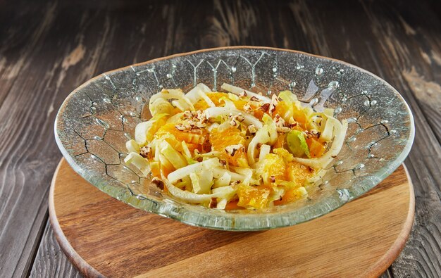 Salada de chicória com laranjas e nozes salgadas. cozinha gourmet francesa Foto Premium