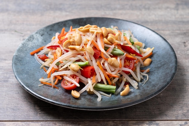 Foto grátis salada de papaia verde som tam thai em mesa de madeira xa