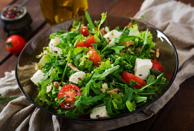 Salada de vitaminas de legumes frescos, ervas, queijo feta e nozes. Menu dietético. Nutrição apropriada.