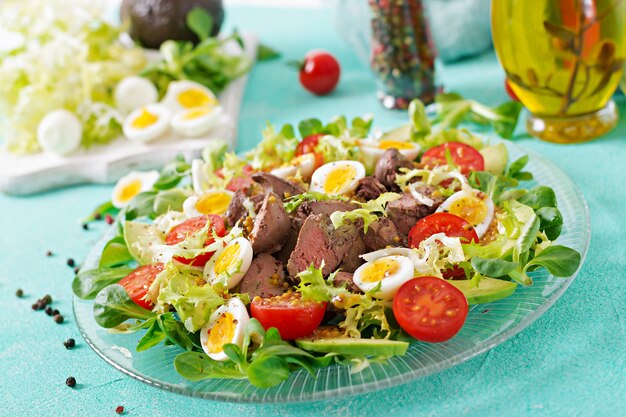 Salada quente de fígado de galinha, abacate, tomate e ovos de codorna. Jantar saudável. Cardápio dietético.