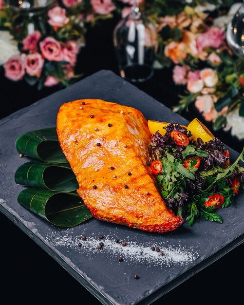 Salmão frito com legumes na mesa