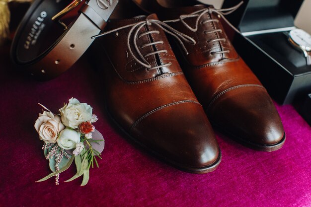 Sapatos do noivo com outros detalhes do casamento