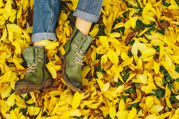 Sapatos em folhas de outono amarelas