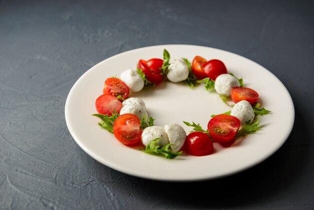 Serviço de restaurante de deliciosa e saudável salada caprese na chapa branca