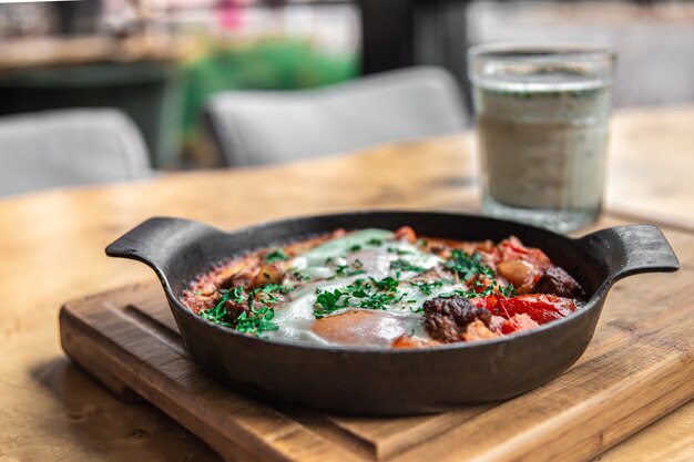 Foto grátis shakshuka em uma frigideira e um copo de comida saudável e saborosa ayran