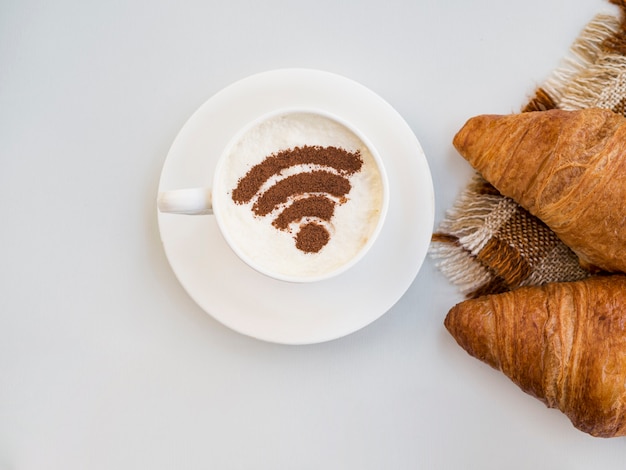 Foto grátis símbolo de wifi no copo com croissants