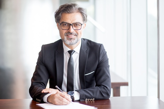 Smiling Handsome Business Leader Making Notes