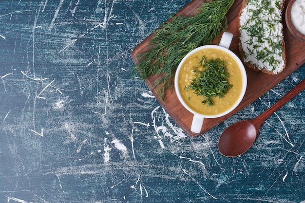 Sopa cremosa com ervas e torradas de pão.