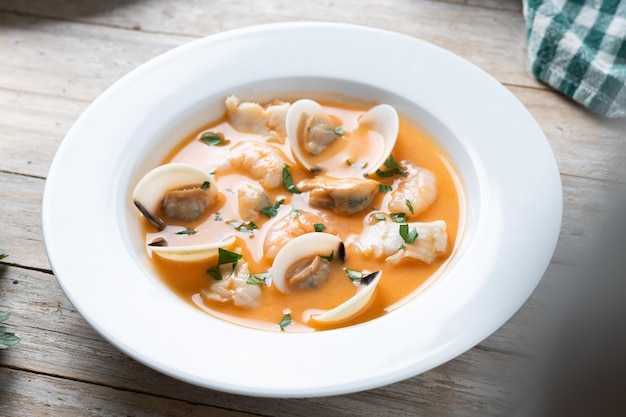 Sopa de frutos do mar na mesa de madeira