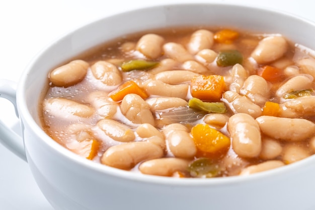 Sopa de grão-de-bico com vegetais em uma tigela isolada em fundo branco xA