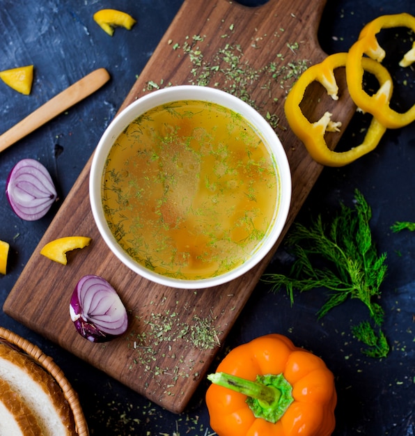 Sopa de legumes com fatias de papel amarelo