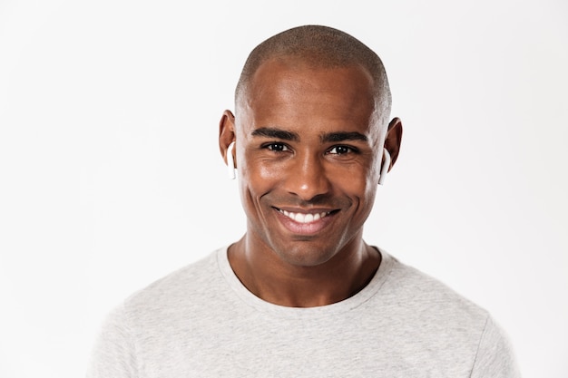 Sorridente jovem Africano em pé isolado