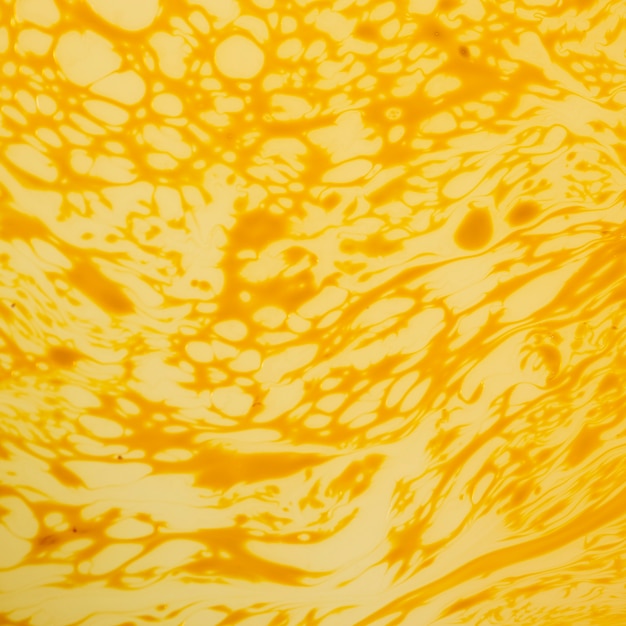 Superfície abstrata dos crepes do creme amarelo