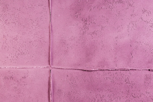 Superfície de parede de concreto rosa com junta