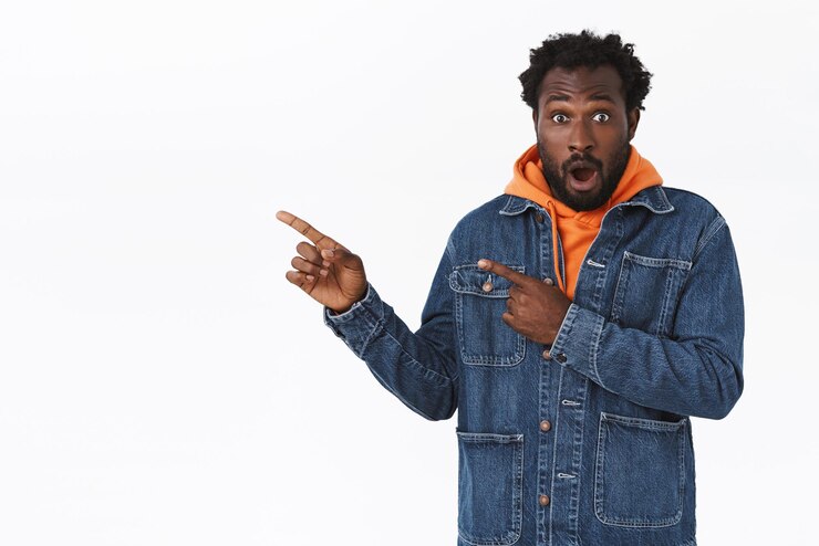 Foto grátis surpreso e animado bonito homem afro-americano barbudo com jaqueta jeans, moletom laranja outono, arfando espantado, mandíbula sem palavras