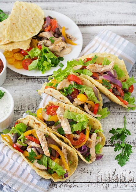 Tacos mexicanos com frango, pimentão, feijão preto e legumes frescos