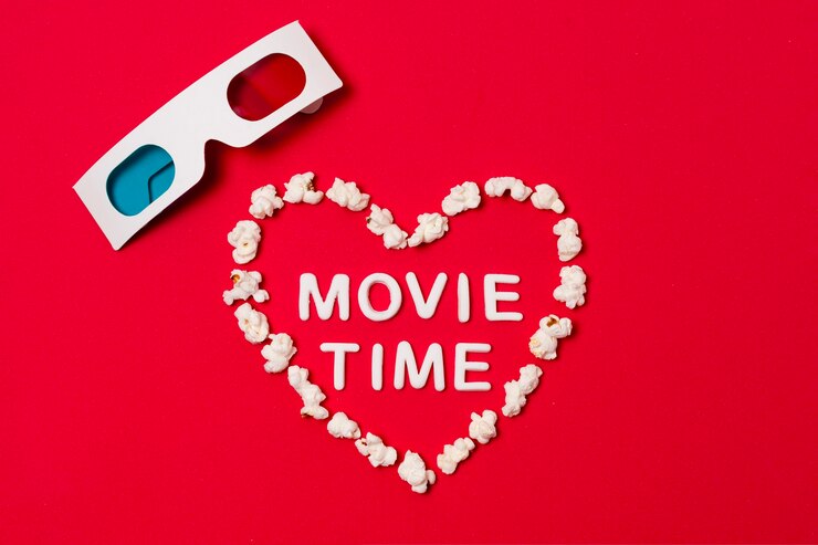 Foto grátis tempo de filme escrito em forma de coração com óculos 3d em fundo vermelho