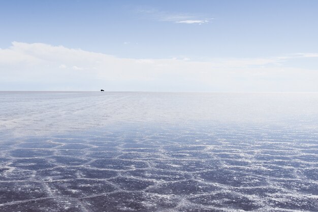 Textura de areia visível sob o mar cristalino e o céu