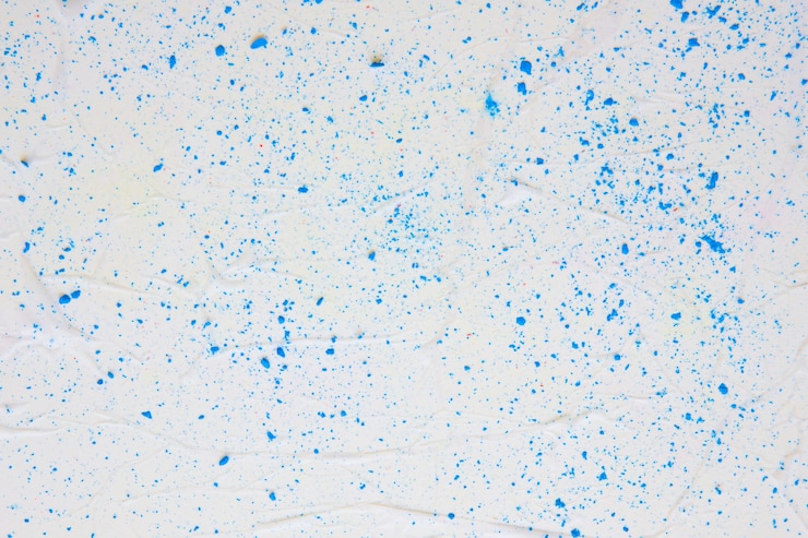 Foto grátis textura de papel colorido com pontos azuis