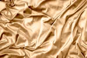 Foto grátis textura de tecido de seda brilhante dourado