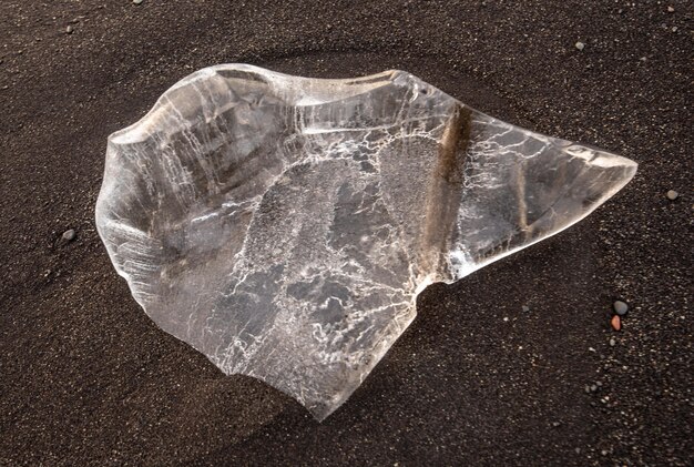 Tiro de alto ângulo de uma pedra de cristal transparente no solo