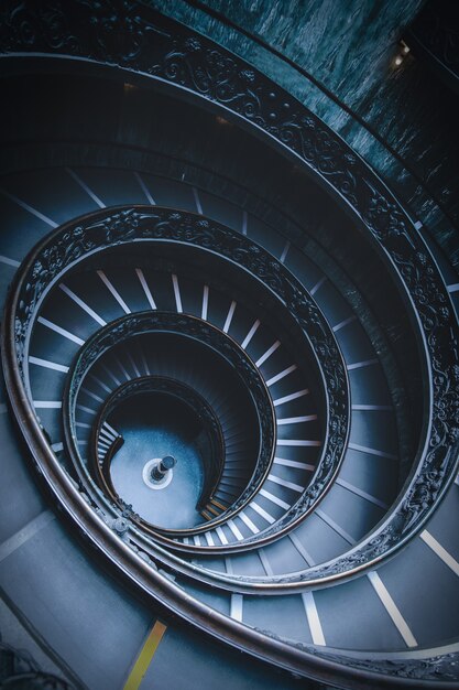 Tiro de ângulo alto de escadas em espiral preto em um museu no Vaticano