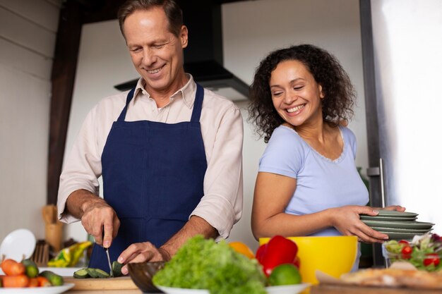 Tiro médio de pessoas cozinhando juntas