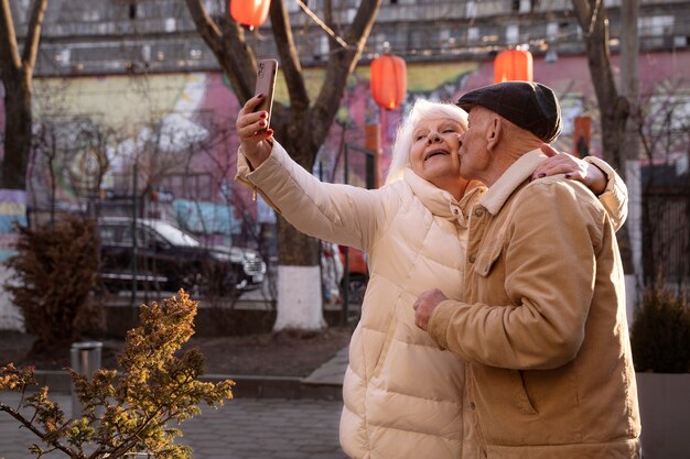 Tiro médio idosos tomando selfie