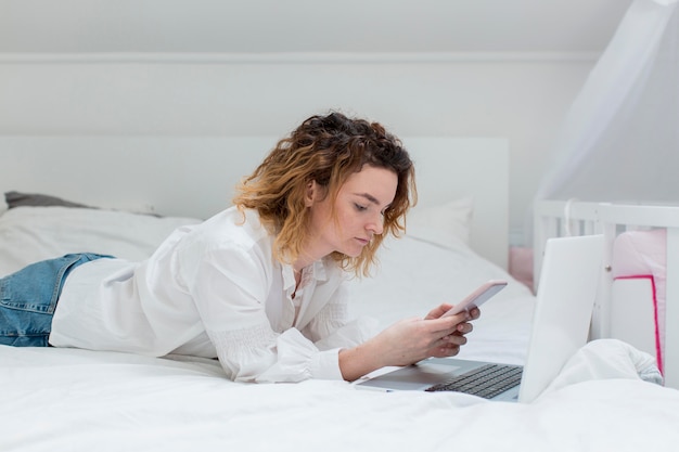 Tiro médio mulher trabalhando na cama