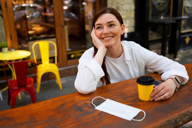 Tiro médio, smiley, mulher segura, xícara café