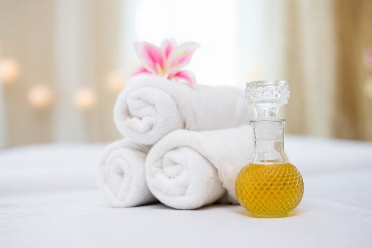 Foto grátis toalha com óleo de spa para ajuste de spa
