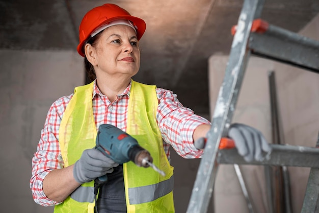 Trabalhador da construção civil sorridente com broca