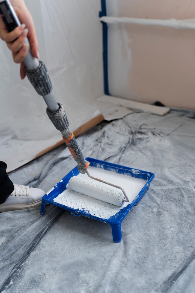 Foto grátis trabalhador da construção civil usando rolo de pintura