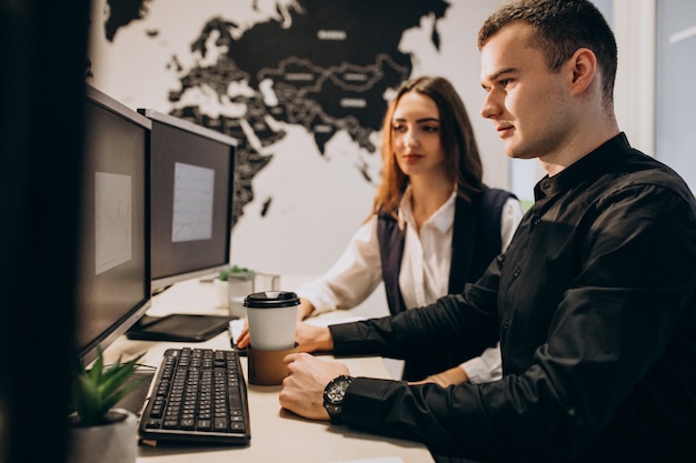 Trabalhadores em uma empresa de ti trabalhando em um computador