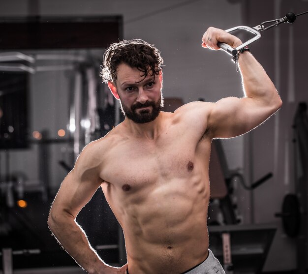 treinamento cross fit na academia, homem musculoso está na academia, o conceito de esporte